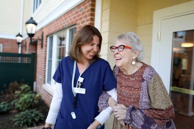 Resident Robin Sharp caregiver assistance outside